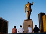 Boys next to statue of Heydar Aliyev.