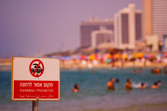 No swimming sign at beach.