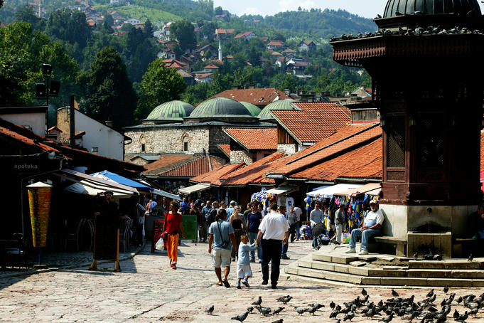 Main square of Turkish section of Bascarsija with rooftops of Brusa Bezistan-Bazar in background, Sebilji fountain in foreground.