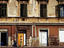 Woman walking past building on Republic Square.