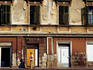 Woman walking past building on Republic Square.