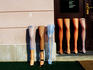 Stockings on mannequin legs outside shop.