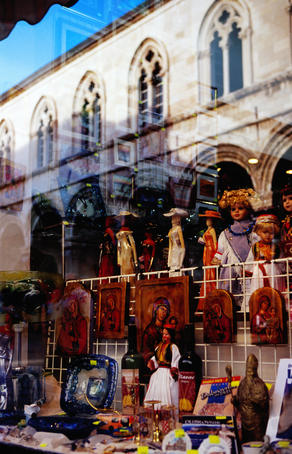 Shop window display and reflection of town hall.
