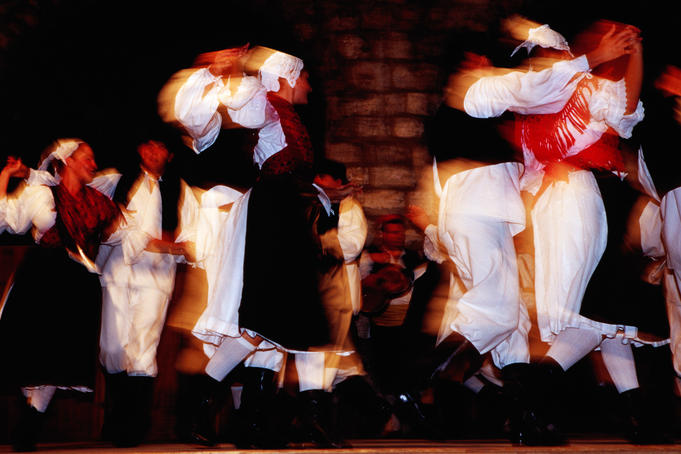 Folk dancers performing traditional dance.