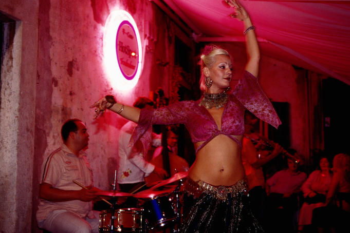 Belly dancer performing with jazz band at Troubadour Cafe.
