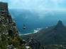 Cable car descending from Table Mountain, Lion's Head in background.