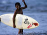 Young local boy heading out for afternoon surf.