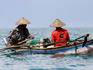 Fishermen in small outriggers.