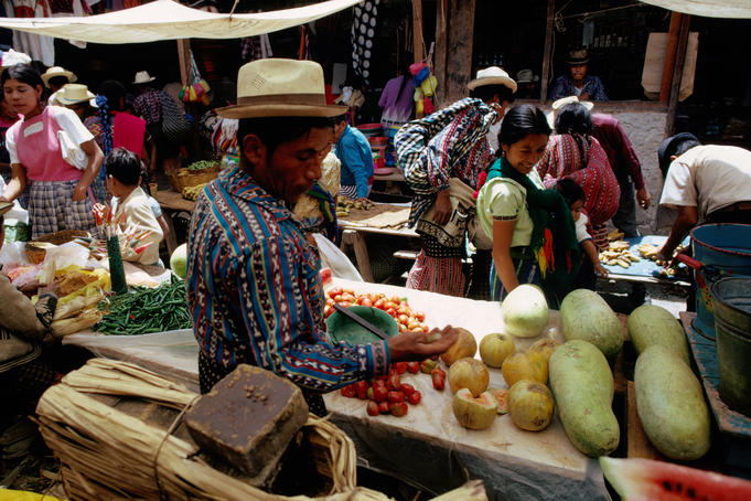 People at the fruit stalls of the Sunday market.