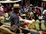 People at the fruit stalls of the Sunday market.