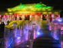 Illuminated ice sculpture of traditional architecture at Ice Festival.