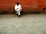 Local man sitting near wall, Marrakesh