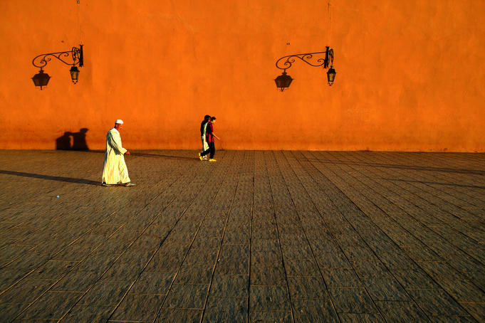 People walking outside walls of Koutoubia Mosque.