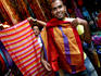 Men holding up silk textiles, Souk 2.