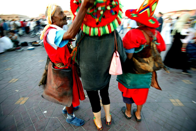 Tourists with waterseller, Djemaa el-Fna.