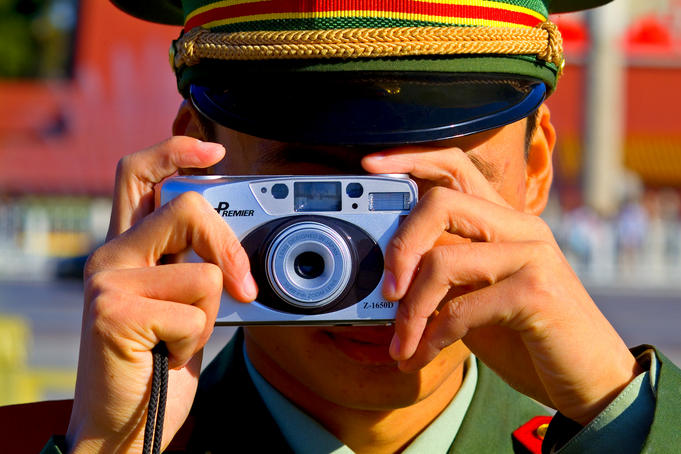 Guard using his camera on China's National Day in Tianamen Square,