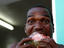 Local man biting into slice of watermelon.