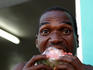 Local man biting into slice of watermelon.