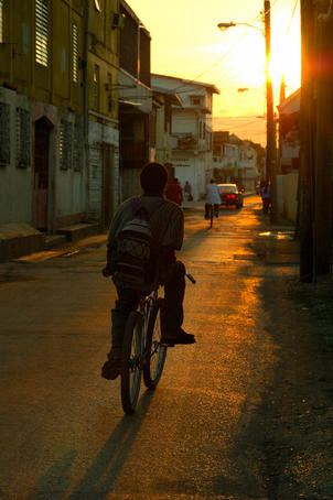 Cruising down Albert Street on push bike at sunset.