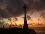 Sunrise at Fort George Lighthouse with local man doing morning exercises.
