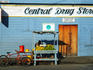 Central Drug Store with man selling melons in Central Downtown Belize City.