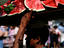 Man carrying watermelon for sale.