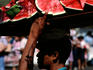 Man carrying watermelon for sale.