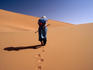 Local man walking in the Sahara.