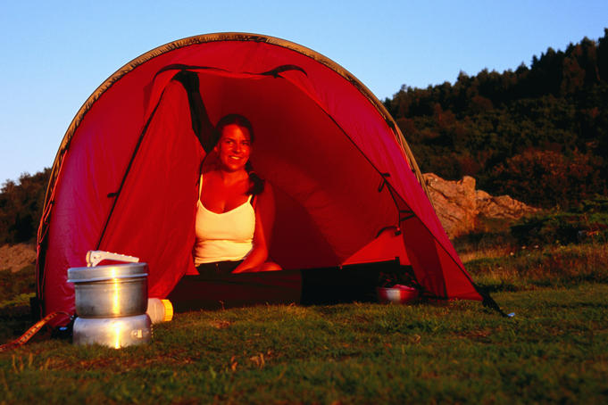 Woman sitting in tent.