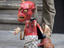 Street entertainer operating devil puppet.