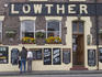 People reading menus outside Lowther public house.