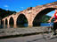 Woman cycling past Alte Brucke.
