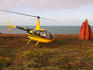 Cape York Helicopter Safaris' helicopter about to take off with termite mound at right, north of Cooktown.