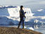 Man standing on Red Island, overlooking ice, Scoresby Sund.