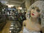 Mannequin and merchandise inside Antiguedades El Abuelo antique store.
