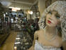 Mannequin and merchandise inside Antiguedades El Abuelo antique store.