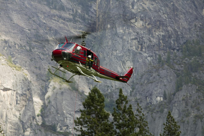 Rescue helicopter in front of one of Yosemite Valley's big walls.