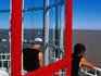 Men on viewing platform on top of lighthouse.