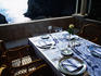 Set tables outside at Restaurant Nautika with sea in background.