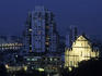 St. Paul ruins with city in background at dusk.