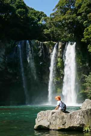 Person looking at waterfall, Cheonjiyeon Gorge.