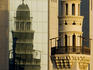 Mosque in front of glass-fronted building.