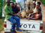 Tourist vehicle with Ba'Aka pygmies driving into park.