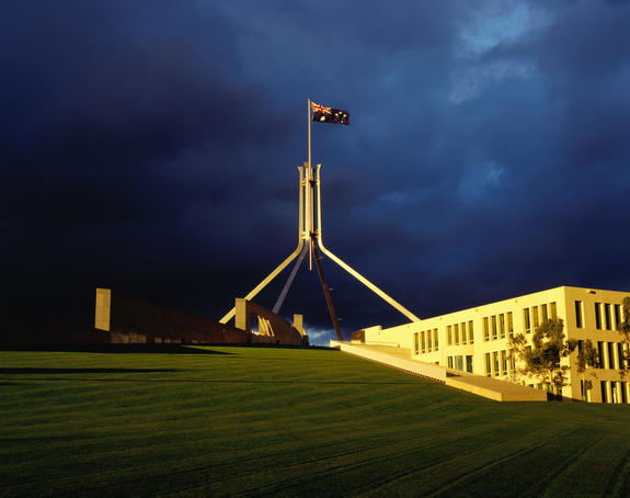 Parliament House with storm clouds in background.