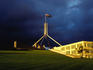 Parliament House with storm clouds in background.