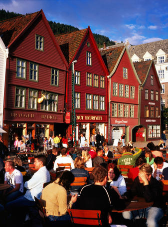 People sitting at outdoor tables at Bryggen Wharf.