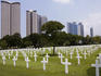 The American Memorial Cemetery at Pateros with buildings in the background.