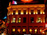 Karl Johan's gate at night with neon sign advertising Freia chocolate.