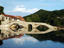 Four-arched bridge of Rijeka Crnojevica reflected in Lake Skadar.