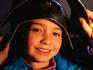 A young girl tries on a helmet at the Royal Armouries in Leeds.
